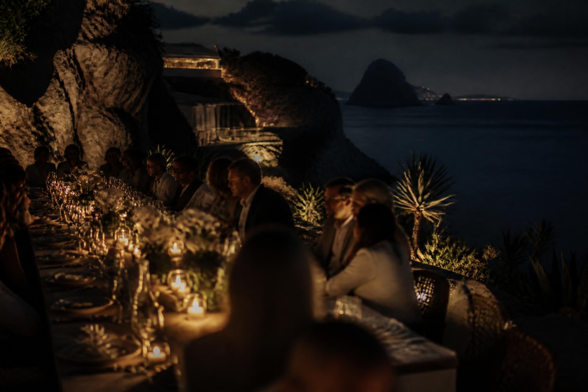 Candlelit table on an Ibiza cliff at dusk